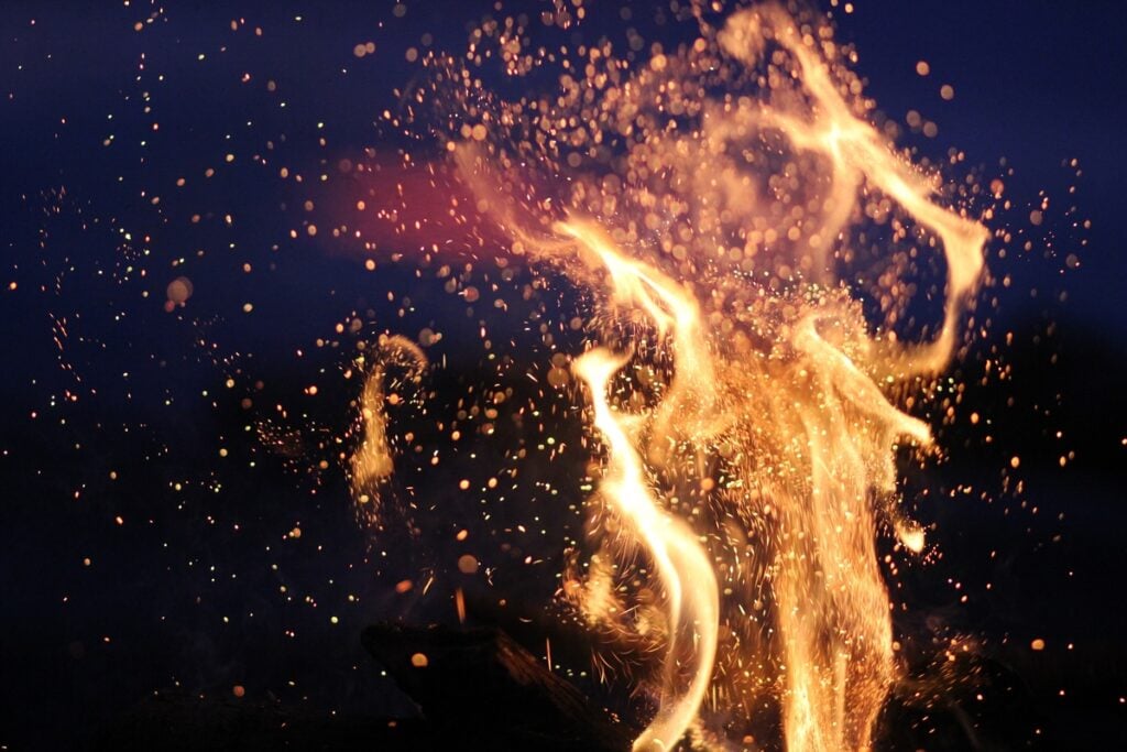 A closeup shot of flames of a bonfire in the darkness